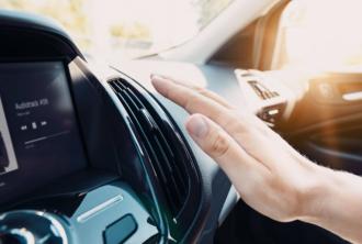 Hand checking the air conditioner in the car