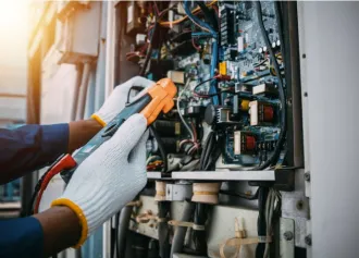 Technician checking switch board control