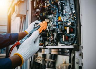 Technician checking switch board control