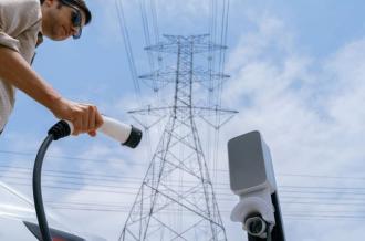 Man recharge EV electric car battery at charging station